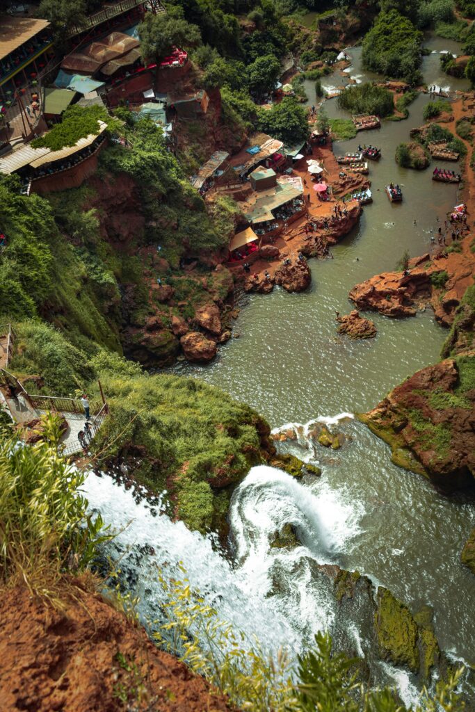 A breathtaking aerial view of Ouzoud Waterfalls cascades surrounded by lush greenery in Morocco.